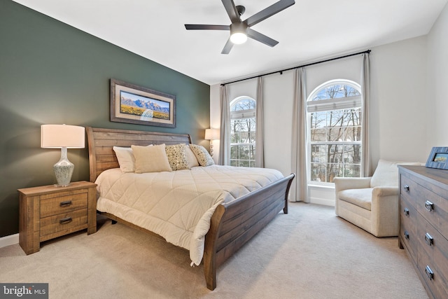 bedroom featuring ceiling fan and light carpet