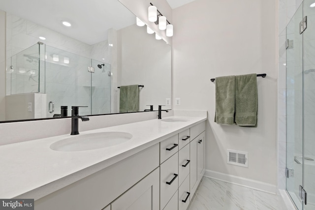 bathroom featuring vanity and a shower with door