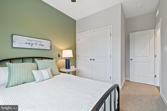 carpeted bedroom with a closet and ceiling fan