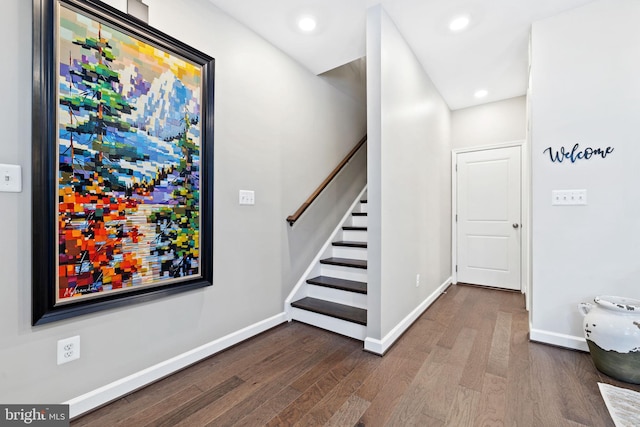 staircase with hardwood / wood-style flooring