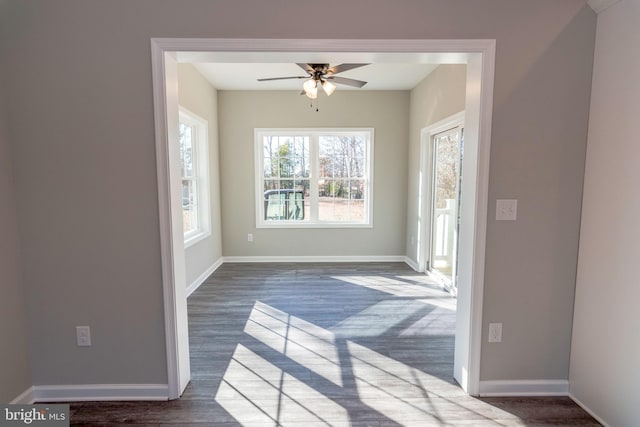 interior space featuring dark wood-style floors, baseboards, and a ceiling fan