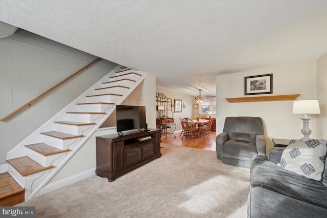 carpeted living room featuring a textured ceiling