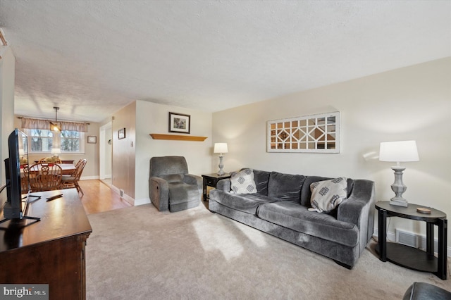 carpeted living room with a textured ceiling