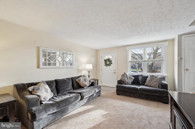 living room featuring light colored carpet and a textured ceiling