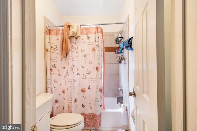 bathroom featuring shower / tub combo with curtain and toilet