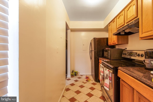 kitchen featuring electric stove and dark stone countertops