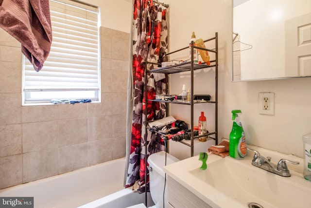 full bathroom with vanity, toilet, and shower / tub combo