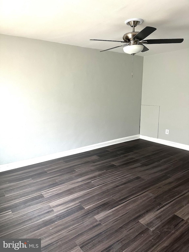 spare room with dark hardwood / wood-style floors and ceiling fan