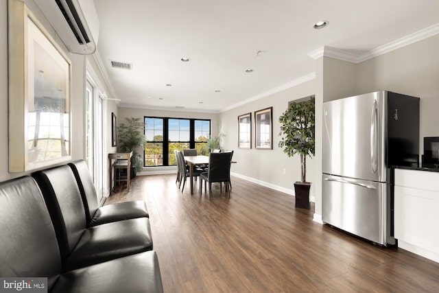 dining room with crown molding, a wall unit AC, and dark hardwood / wood-style floors