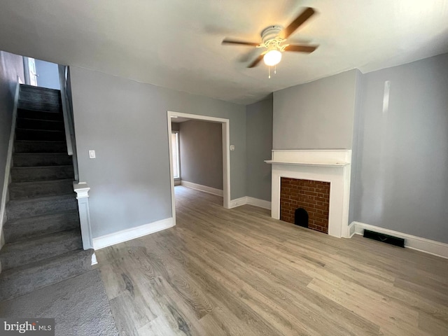 unfurnished living room with ceiling fan and light hardwood / wood-style floors