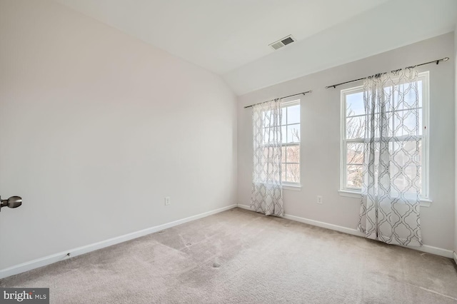 empty room with lofted ceiling and carpet floors