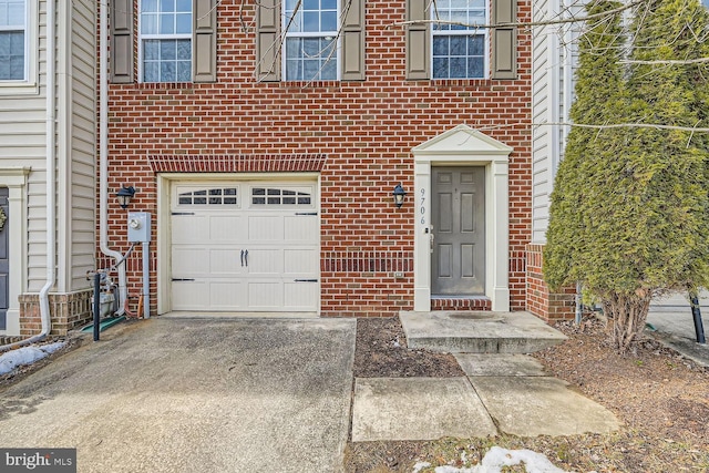 doorway to property with a garage