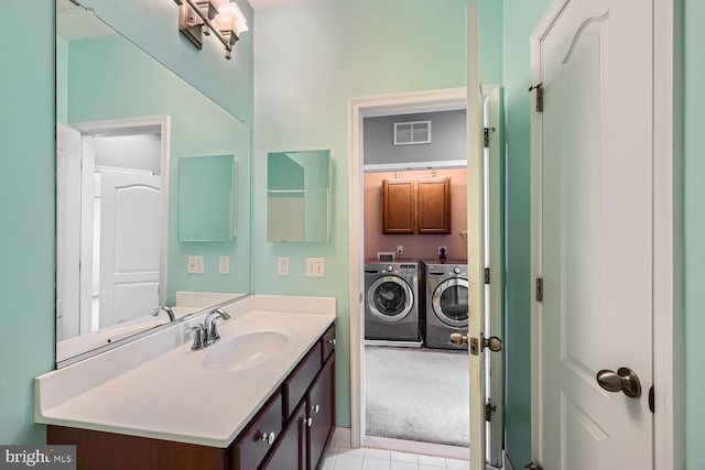 bathroom featuring vanity and washer and clothes dryer