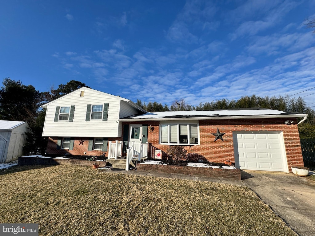 split level home with a front lawn and a garage