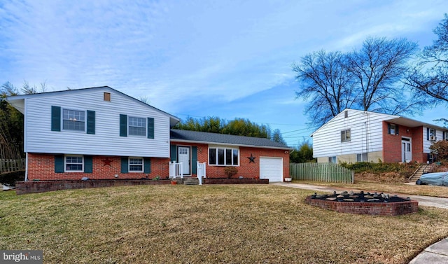 split level home featuring a front yard and a garage