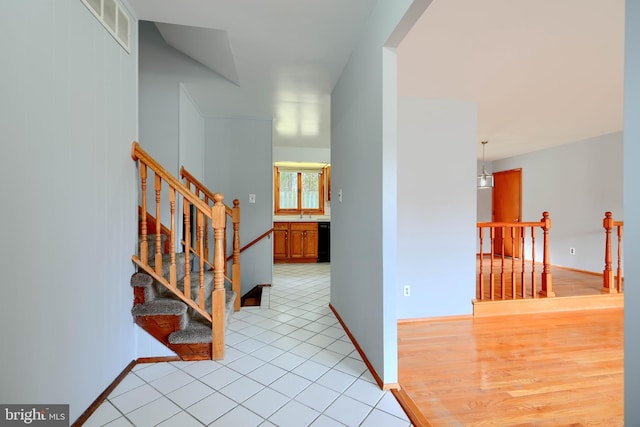 corridor featuring light tile patterned floors