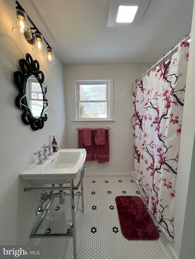 bathroom with sink and a shower with shower curtain