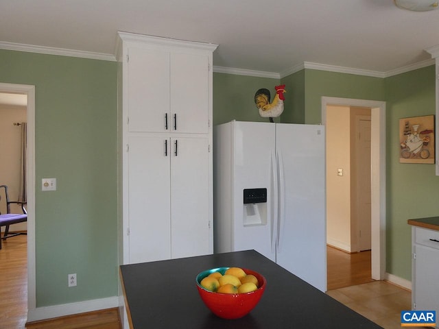 kitchen with white cabinetry, white fridge with ice dispenser, crown molding, and light hardwood / wood-style flooring