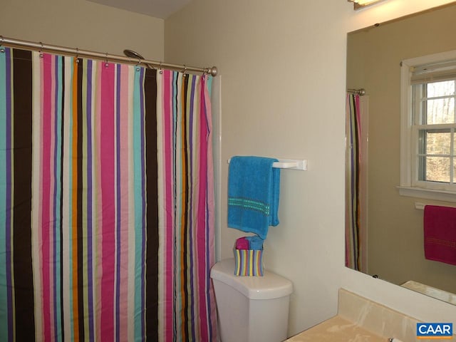 bathroom with vanity, toilet, and a shower with shower curtain