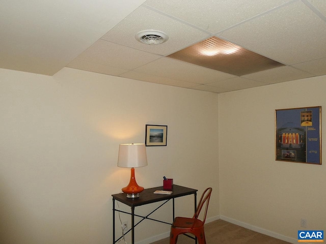 office space with carpet floors and a paneled ceiling