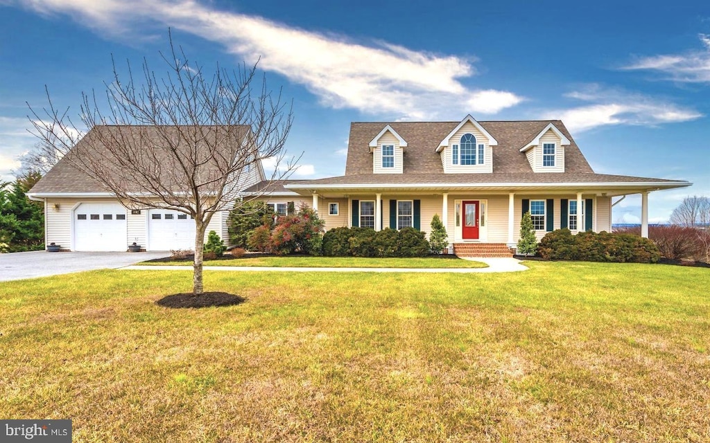 new england style home featuring a garage and a front yard