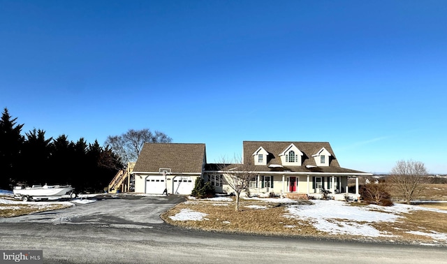 cape cod-style house featuring a garage