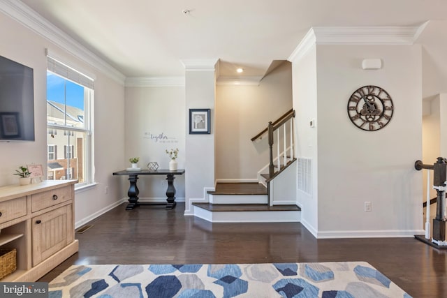 foyer entrance featuring crown molding and dark hardwood / wood-style flooring