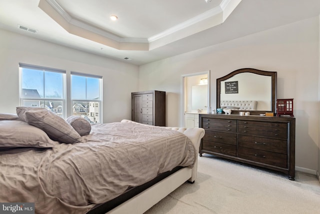 carpeted bedroom featuring crown molding, connected bathroom, and a raised ceiling