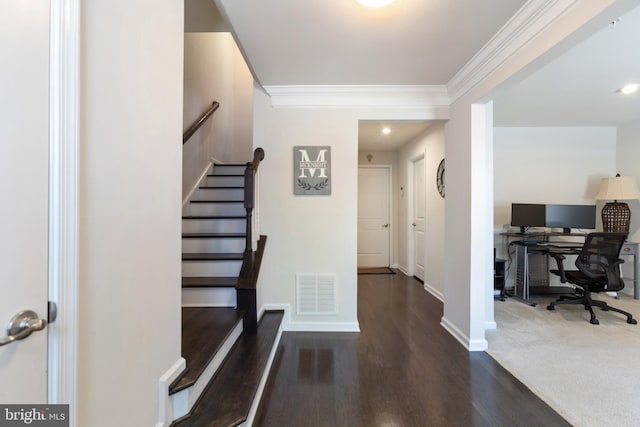 entrance foyer featuring ornamental molding and dark hardwood / wood-style flooring