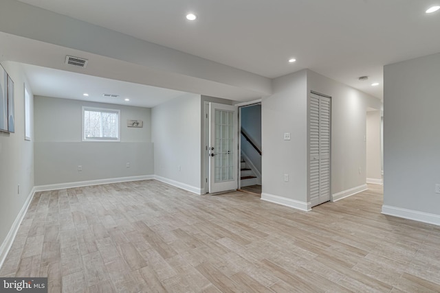 basement featuring baseboards, light wood-type flooring, visible vents, and recessed lighting