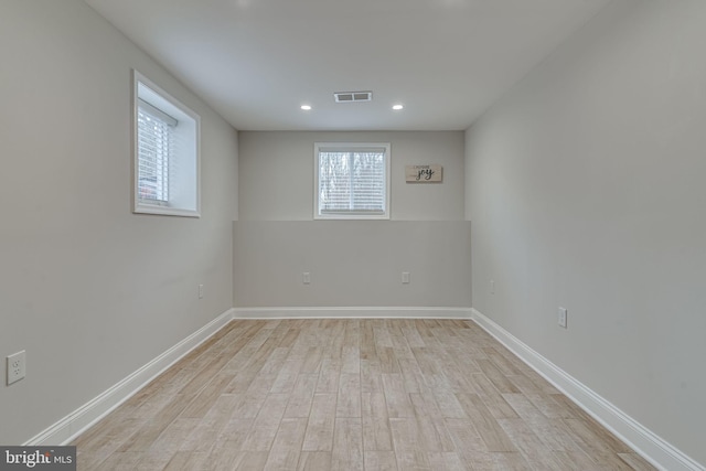 spare room with light wood-style floors, visible vents, baseboards, and recessed lighting