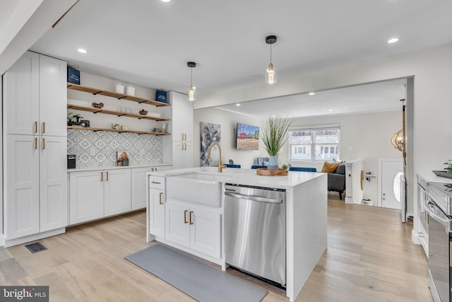 kitchen with open shelves, light countertops, stainless steel dishwasher, white cabinetry, and a sink