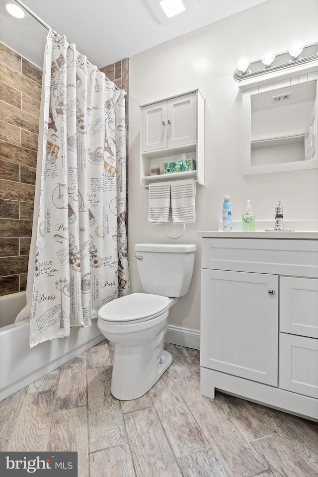 full bathroom with vanity, toilet, and shower / tub combo