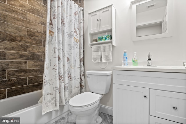 full bathroom with vanity, shower / tub combo, and toilet