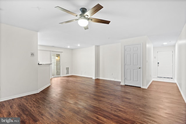 unfurnished living room with dark wood-type flooring and ceiling fan