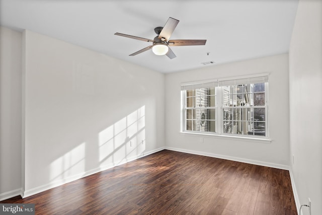 unfurnished room featuring ceiling fan and dark hardwood / wood-style floors