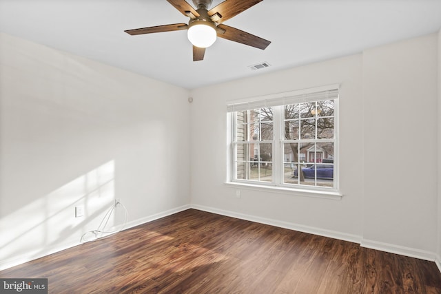 empty room featuring ceiling fan and dark hardwood / wood-style floors