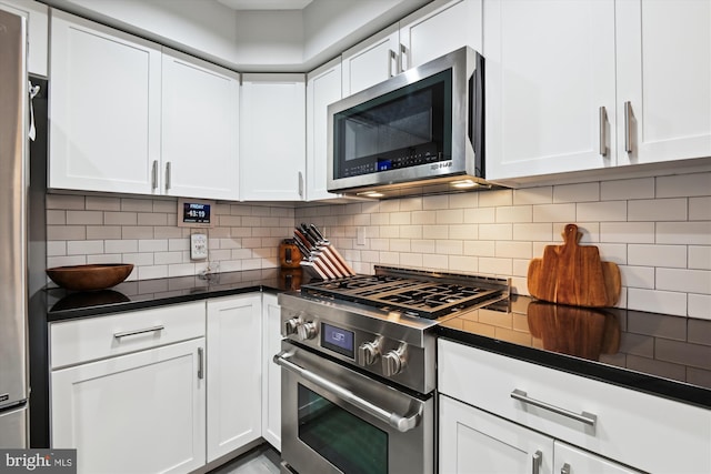 kitchen with white cabinetry, tasteful backsplash, and appliances with stainless steel finishes