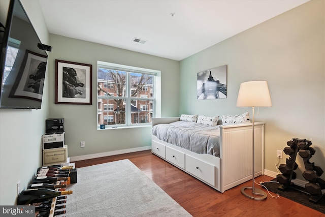 bedroom with hardwood / wood-style floors