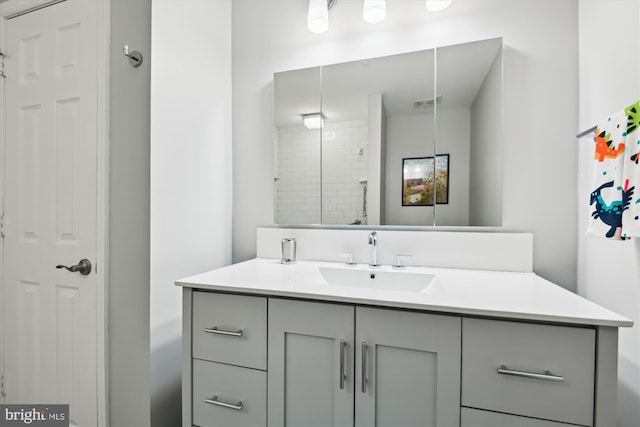 bathroom with walk in shower and vanity