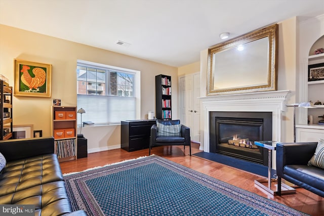 sitting room with hardwood / wood-style flooring