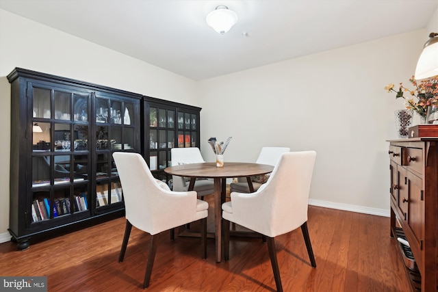 dining space with wood-type flooring