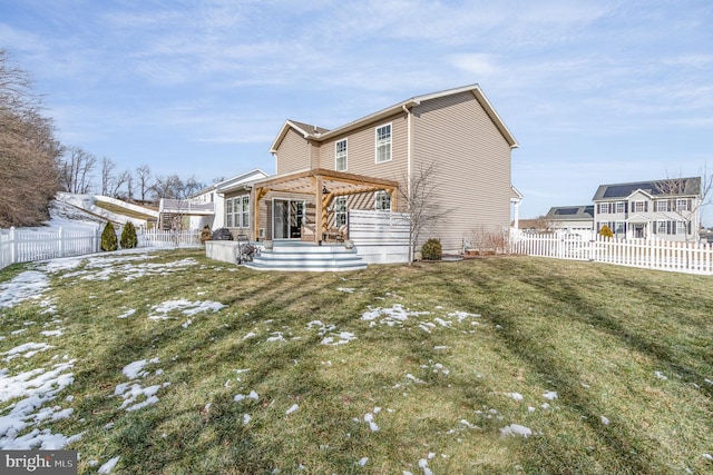 rear view of house featuring a yard and a gazebo