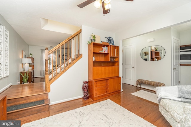 living room featuring hardwood / wood-style flooring and ceiling fan