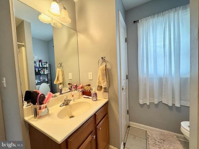 bathroom featuring vanity, toilet, and tile patterned flooring