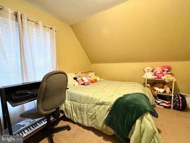 bedroom featuring vaulted ceiling and carpet floors