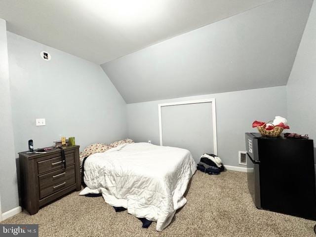 bedroom with light carpet and vaulted ceiling