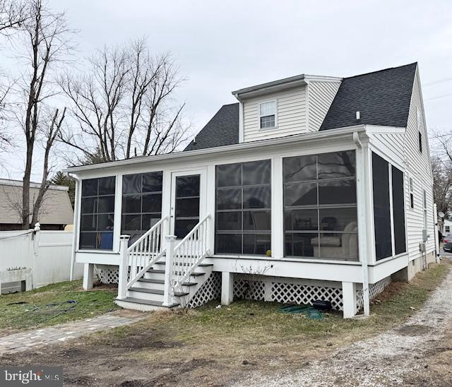 back of house featuring a sunroom