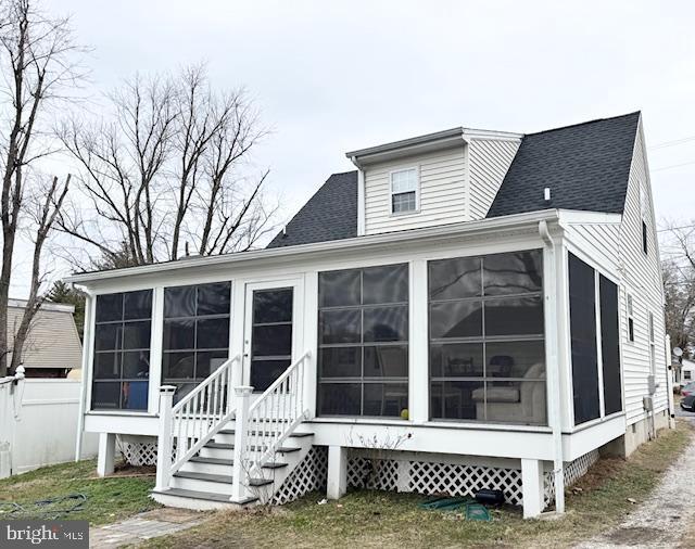 back of house with a sunroom