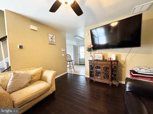 living room featuring ceiling fan and wood-type flooring